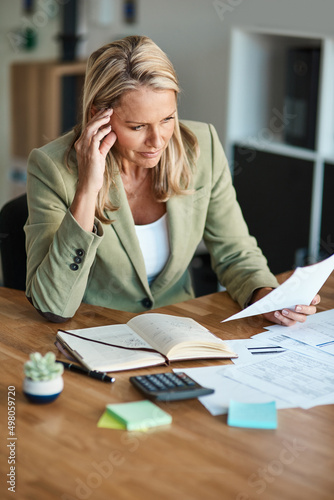 Racking her brain. High angle shot of a mature businesswoman looking thoughtful while working in her corporate office.