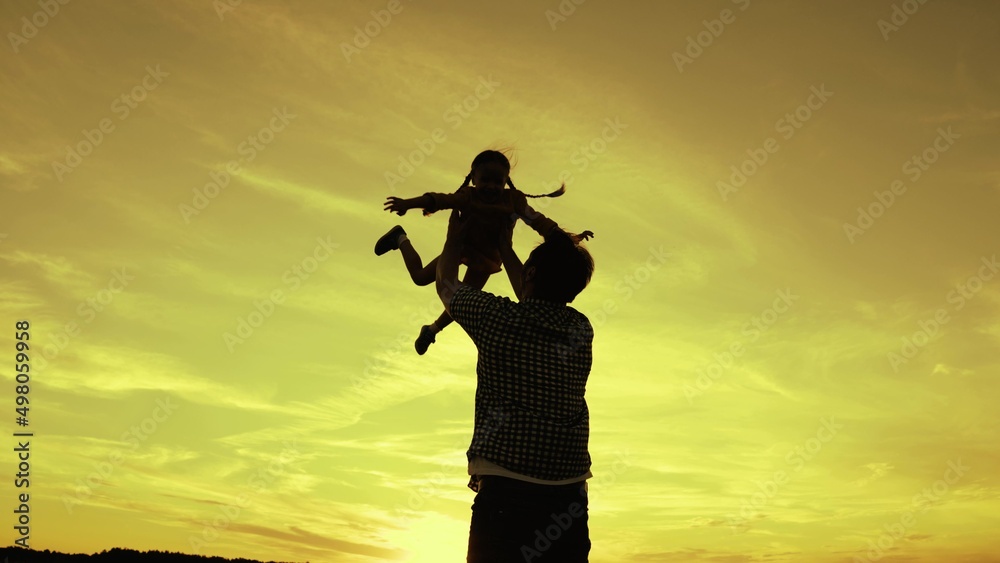happy family concept. father plays with small child flying airplane pilot. happy family park. daddy kid superhero flies against sky. day off daughter child with dad. childhood dream to fly outdoors.