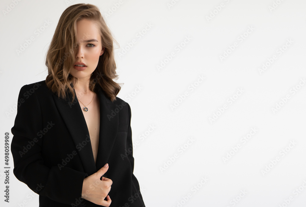 Natural look. Beauty model woman . Model test portrait with young beautiful fashion model posing on grey background. Blond woman in a black blazer . Natural makeup Natural look. Beauty model woman . Model test portrait with young beautiful fashion model posing on grey background. Blond woman in a black blazer . Natural makeup