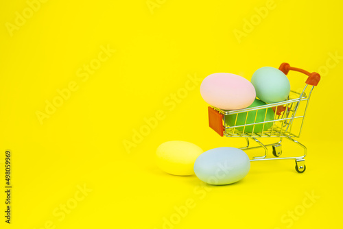 Easter . Basket with Easter eggs on a yellow background. With place for text. The concept of a holiday, promotion, products, shopping, sale, discounts, gifts. High quality photo