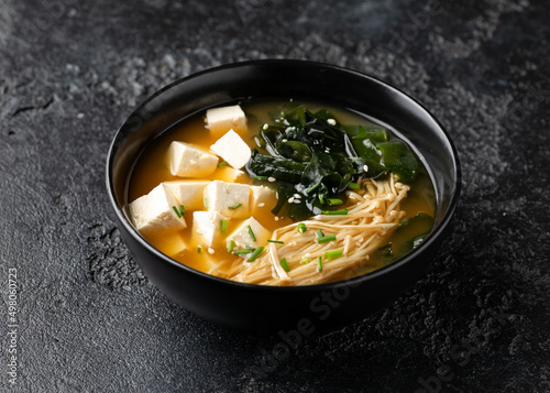 Rich miso soup with enoki mushrooms, wakame seaweed and tofu, vegetarian, vegan Asian food.