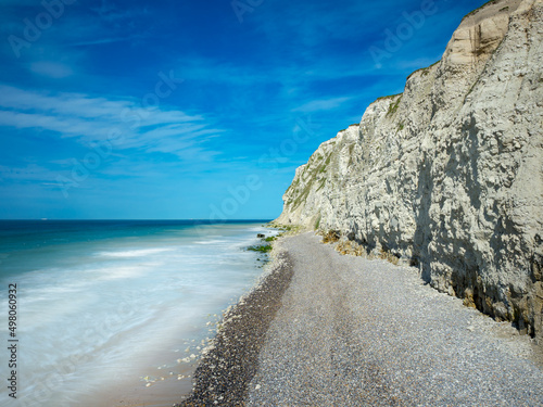 White chalk cliffs of the French Opal Coast and pebble beach facing the English Channel and a turquoise sea with beautiful wave movements photo