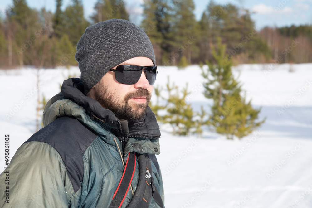 Portrait of a man, a tourist in a winter forest. Outdoor recreation. Portrait of a man, a tourist in a winter forest. Outdoor recreation.