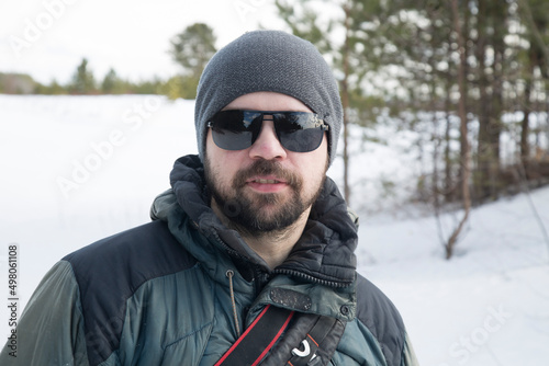 Portrait of a man, a tourist in a winter forest. Outdoor recreation.