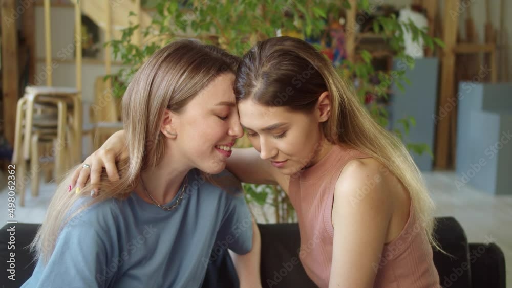 A young lovely lgbt couple is sitting together, hugging and enjoying each other A young lovely lgbt couple is sitting together, hugging and enjoying each other