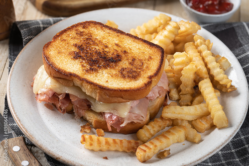 Grilled ham and cheese sandwich and french fries