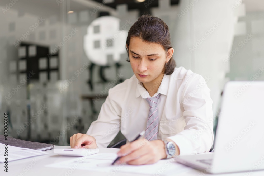 Business concept, Businessman checking financial graph on document and analyze to make report Business concept, Businessman checking financial graph on document and analyze to make report