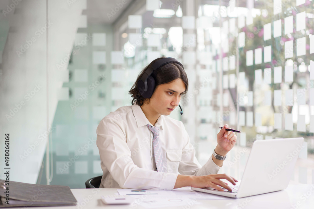 Business concept, Businessman wearing headphone to explain planning with team on video conference Business concept, Businessman wearing headphone to explain planning with team on video conference