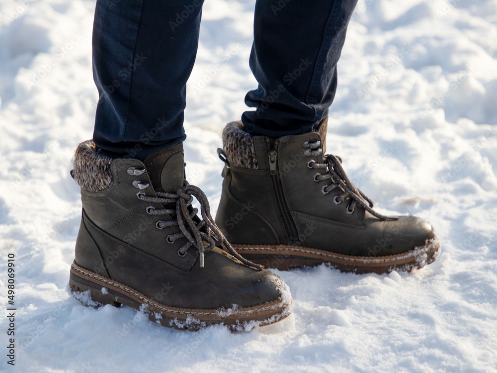 Person in boots on snow Person in boots on snow