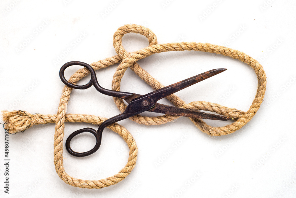 vintage scissors and jute rope on white background