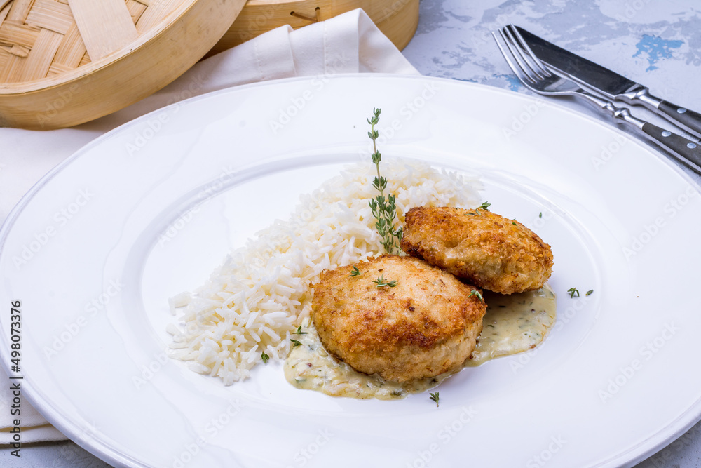 chicken cutlets with boiled rice side view