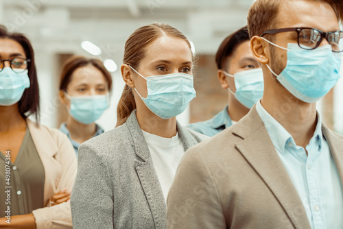 Multinational business people wearing protective face masks