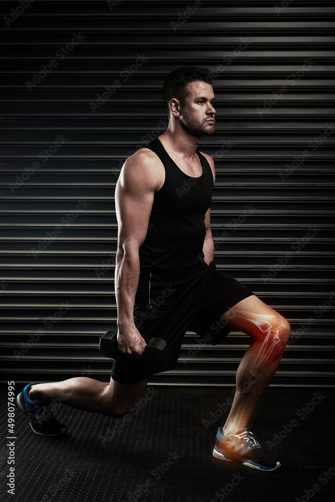 Obraz premium Lunges can put strain on your knees. Full length shot of an athletic young man working out with dumbbells in the studio.