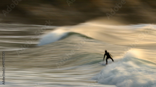 Art photo of surfing in the dawn at Vic Bay, South Africa