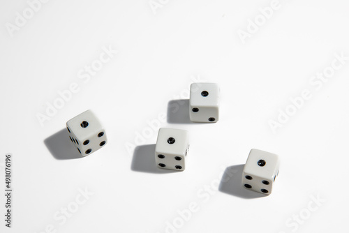 White dice with a one standing close to each other on a white background. Win or lose. Catch your luck. Gambling equipment.