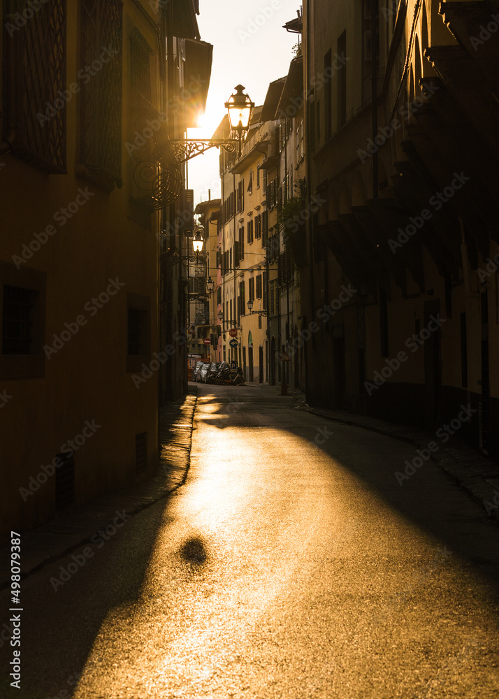 old medieval street in Florence Italy with sun coming through 