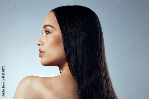 A great hairstyle is the best accessory. Studio shot of an attractive young woman posing against a grey background. photo