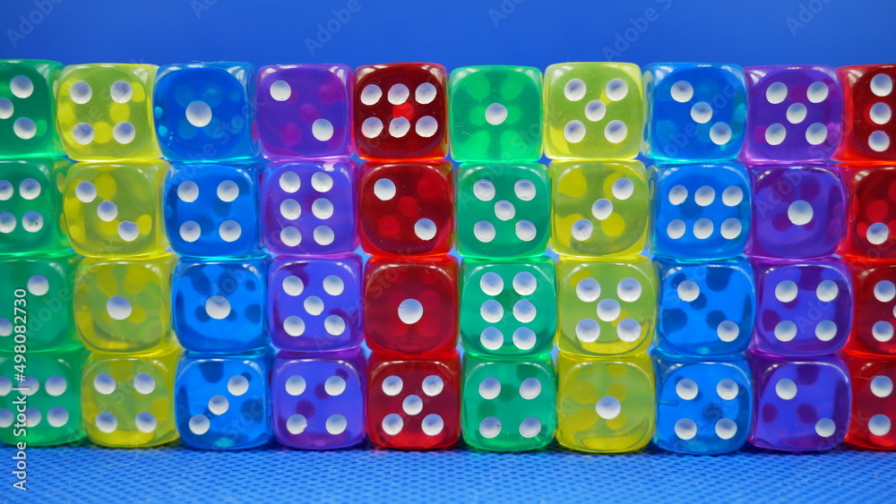 Colorful dice stacked against the wall Colorful dice stacked against the wall