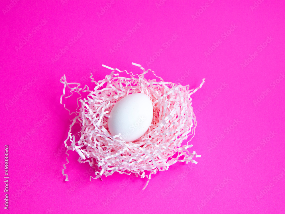 colored Easter eggs on a bright pink nest background with a top view, an image with selective focus. colored Easter eggs on a bright pink nest background with a top view, an image with selective focus.