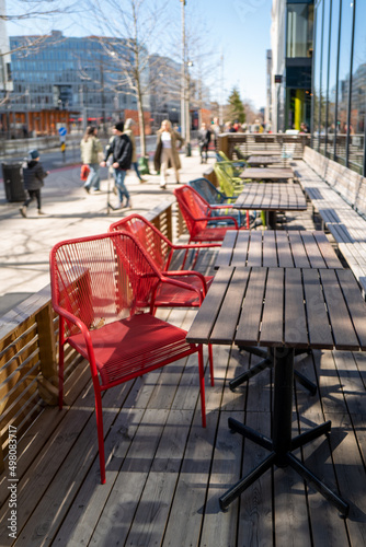 Outdoor restaurant on a sunny day with colourful chairs