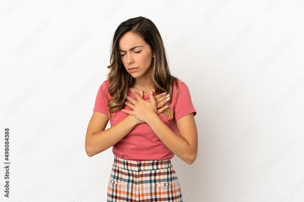 Young woman over isolated background having a pain in the heart Young woman over isolated background having a pain in the heart