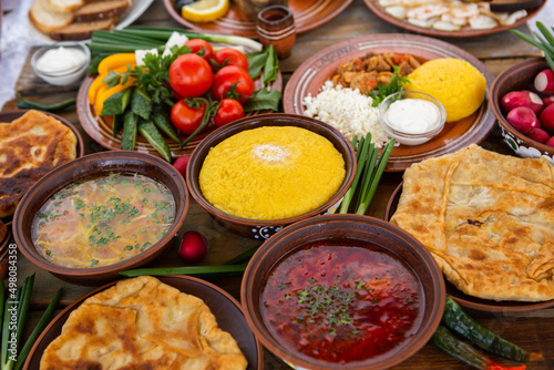 Homemade Romanian Food with pies, polenta, borscht, vegetables, fish, meat, stew, cheese and wine. Traditional dishes from Romania and the Republic of Moldova.