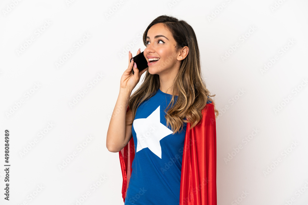 Super Hero woman over isolated white background keeping a conversation with the mobile phone