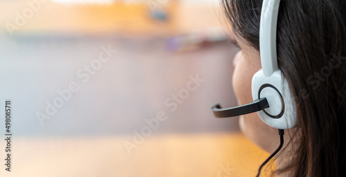 Call center, home office, customer support, help desk concept. Woman with headset work on a laptop