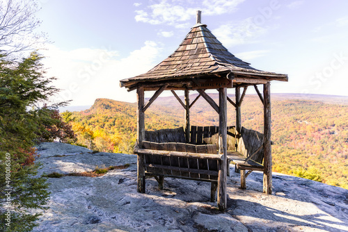 A beautiful wooden gazebo with fall foliage colors beginning to show on a mountain ridge. Monhonk, Shawangunk Ridge New York 