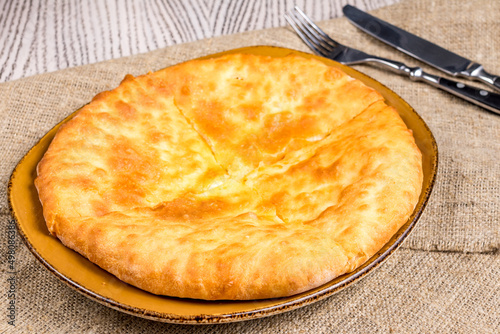 khachapuri with cheese, imeretian khachapuri, georgian cuisine on wooden table photo