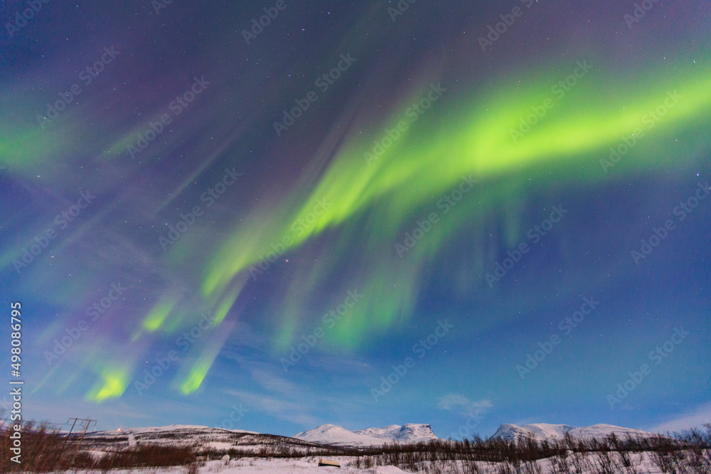 Abisko, Aurora Borealis in Lapland. Sweden lights in the sky full of stars. Land of the Sami people. 
Solar wind colors