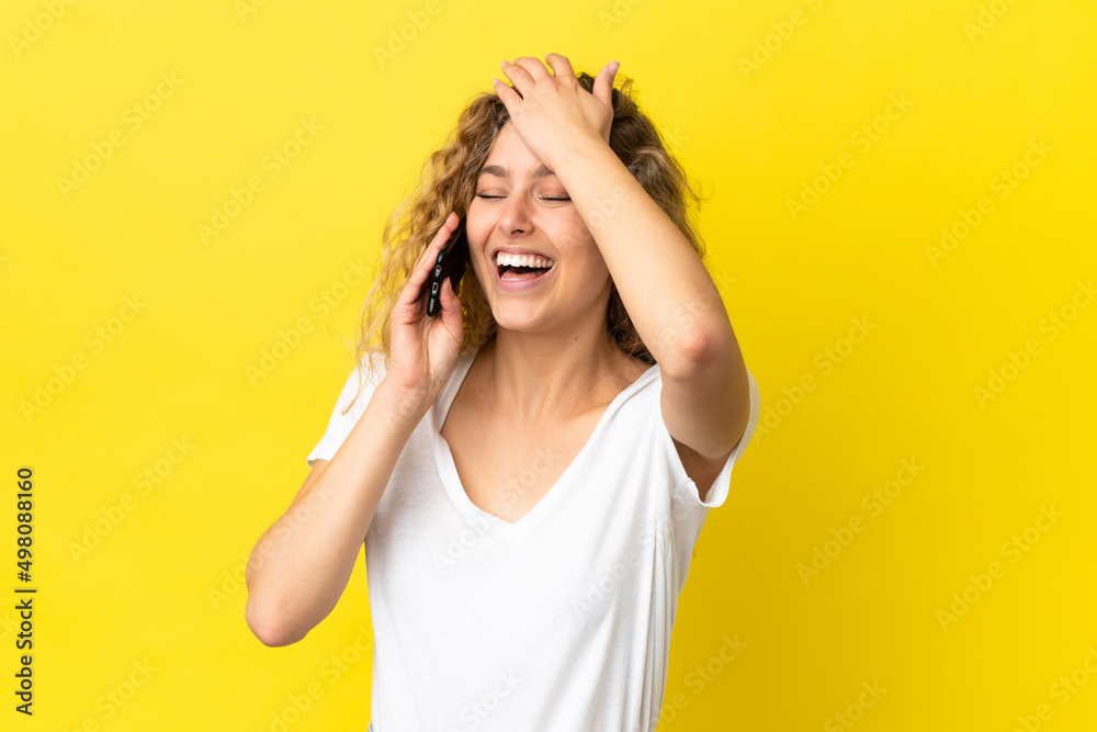 Young blonde woman using mobile phone isolated on yellow background has realized something and intending the solution Young blonde woman using mobile phone isolated on yellow background has realized something and intending the solution