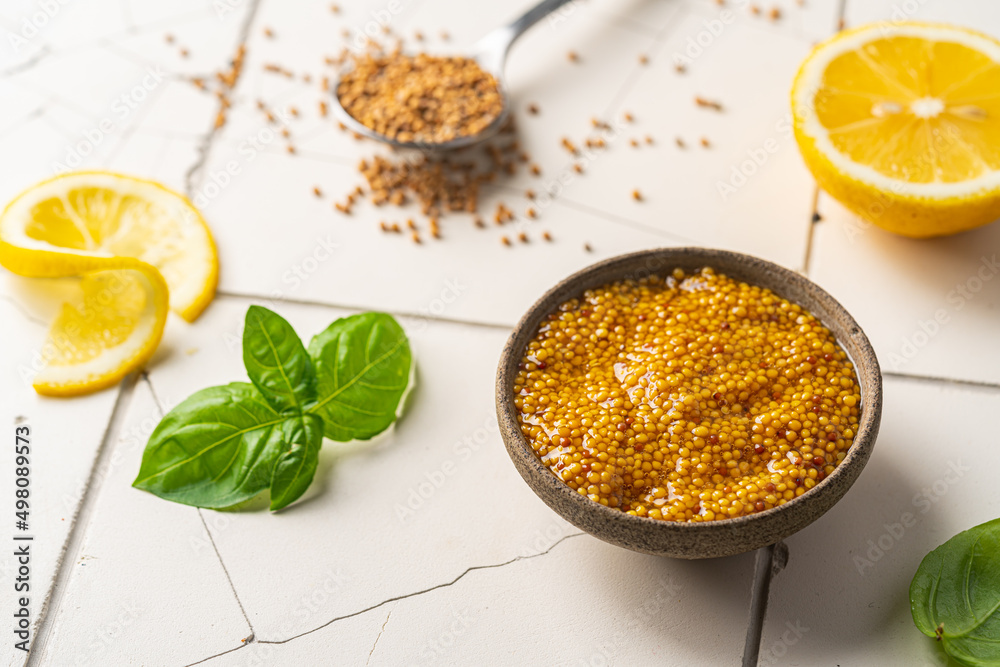 Fresh homemade organic dijon mustard in a bowl on white background, close up Fresh homemade organic dijon mustard in a bowl on white background, close up