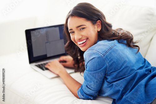 Ive really taken to this whole blogging thing. Shot of a young woman browsing the web on her laptop at home.