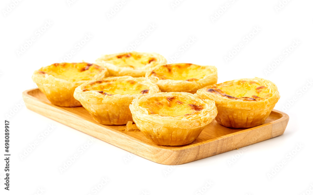 Egg tart on wooden plate isolated on white background Egg tart on wooden plate isolated on white background