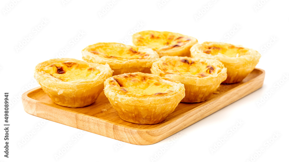 Egg tart on wooden plate isolated on white background Egg tart on wooden plate isolated on white background