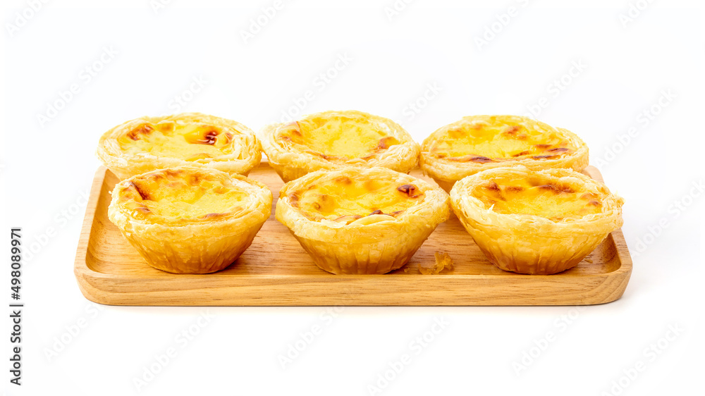 Egg tart on wooden plate isolated on white background Egg tart on wooden plate isolated on white background