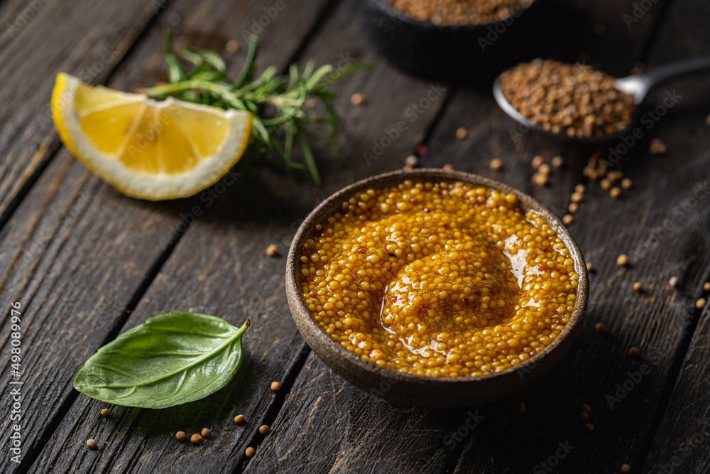 Fresh homemade organic dijon mustard in a bowl on wooden background, close up Fresh homemade organic dijon mustard in a bowl on wooden background, close up