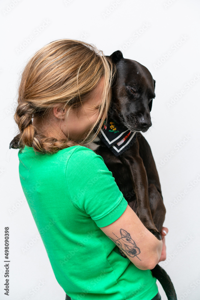 Young caucasian woman with her dog over isolated background Young caucasian woman with her dog over isolated background