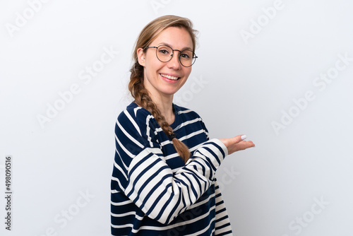 Young caucasian woman isolated on white background presenting an idea while looking smiling towards