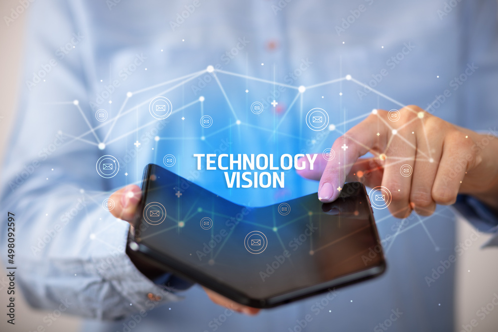 Businessman holding a foldable smartphone, new technology concept Businessman holding a foldable smartphone, new technology concept