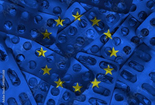 European Union flag and empty packaging of medicine pills in the background. EU flag © Bojanikus