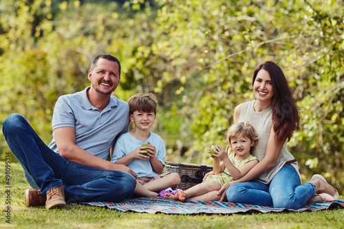Family time is the best time. Portrait of a happy family bonding together outdoors.
