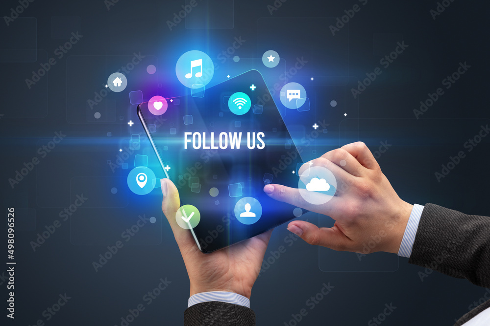 Fototapeta premium Businessman holding a foldable smartphone
