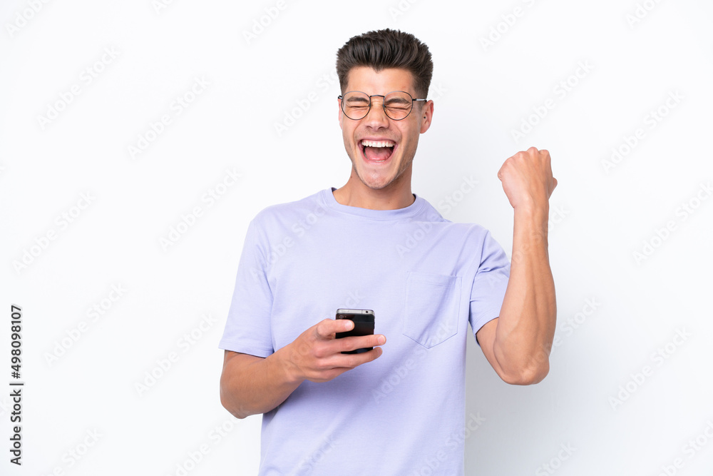Young caucasian man isolated on white background with phone in victory position Young caucasian man isolated on white background with phone in victory position