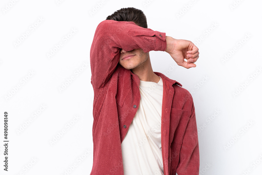 Young caucasian man isolated on white background covering eyes by hands