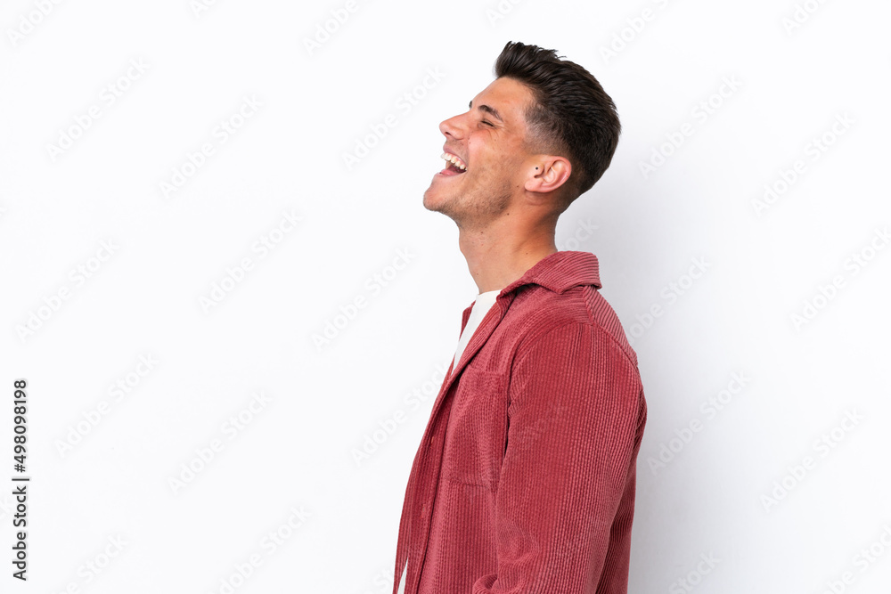 Young caucasian man isolated on white background laughing in lateral position Young caucasian man isolated on white background laughing in lateral position