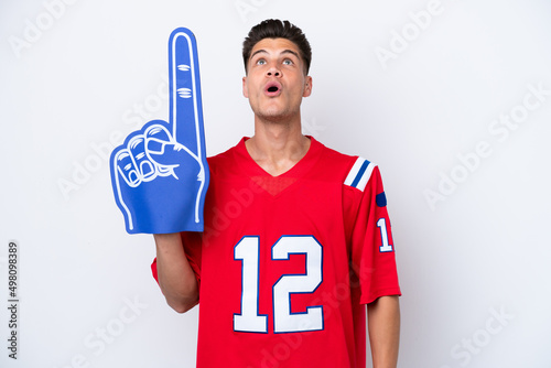 Young caucasian sports fan man isolated on white background looking up and with surprised expression