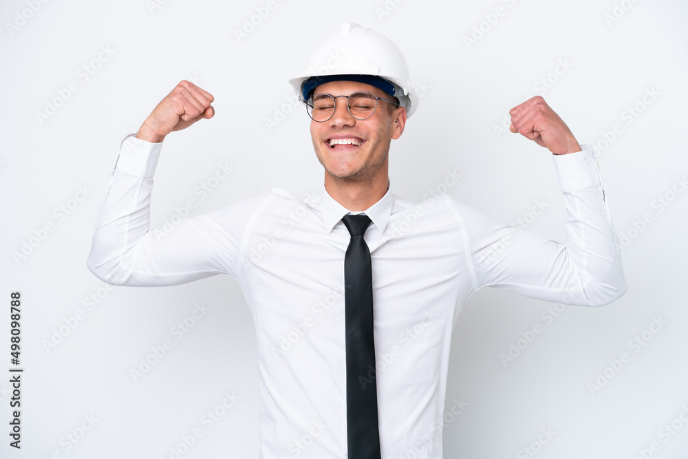 Young architect caucasian man with helmet and holding blueprints isolated on white background doing strong gesture Young architect caucasian man with helmet and holding blueprints isolated on white background doing strong gesture