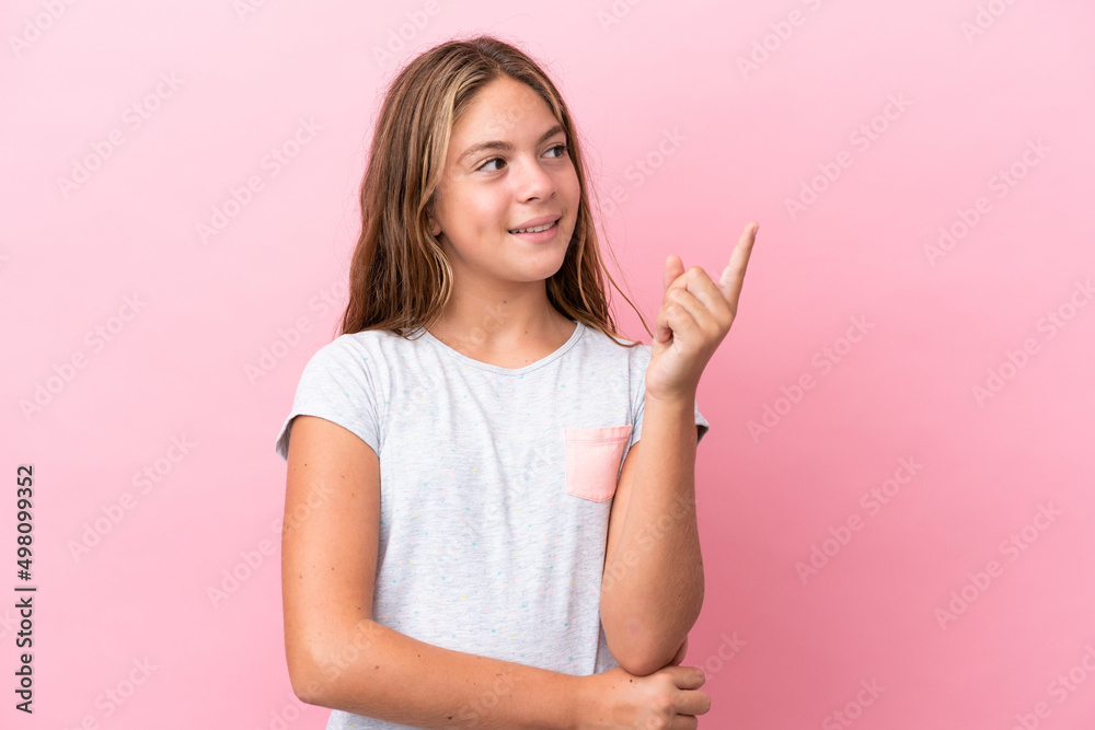 Little caucasian girl isolated on pink background pointing up a great idea Little caucasian girl isolated on pink background pointing up a great idea